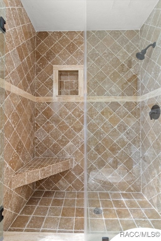 bathroom with tiled shower