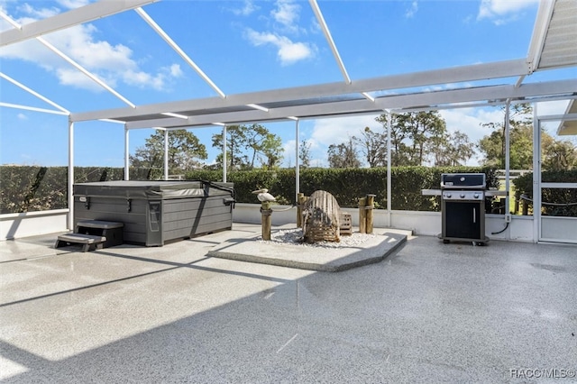 view of patio / terrace with a lanai, a hot tub, and area for grilling