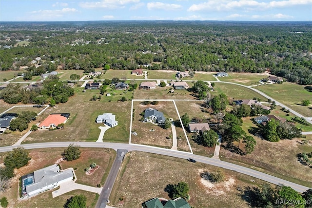 birds eye view of property with a wooded view