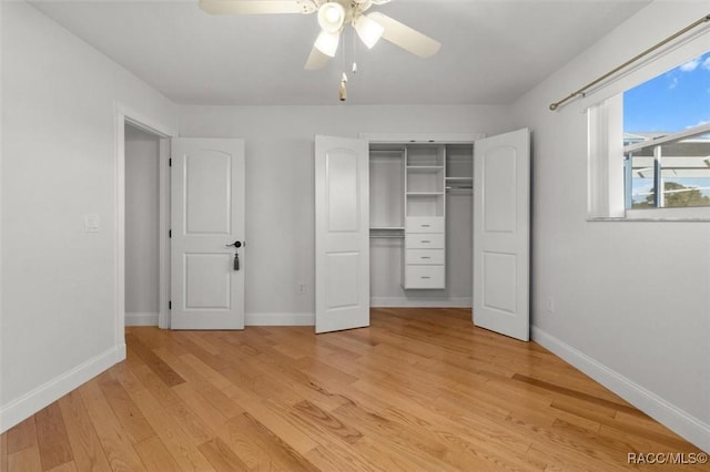 unfurnished bedroom featuring light wood-type flooring, a closet, and baseboards