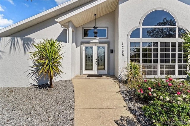 property entrance with french doors and stucco siding