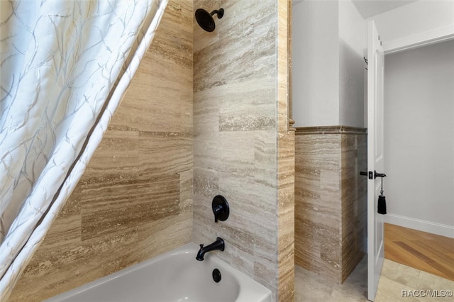 full bathroom featuring tile walls, shower / bathtub combination with curtain, and wood finished floors