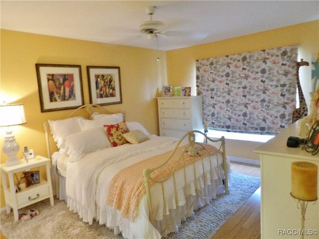 bedroom with ceiling fan and light hardwood / wood-style flooring