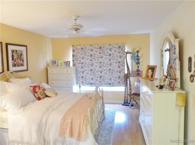 bedroom with ceiling fan and light wood-type flooring