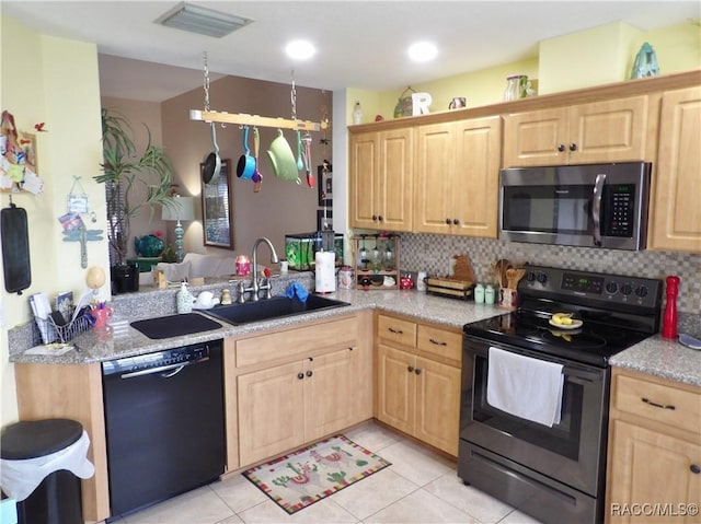 kitchen with tasteful backsplash, sink, light tile patterned floors, kitchen peninsula, and stainless steel appliances