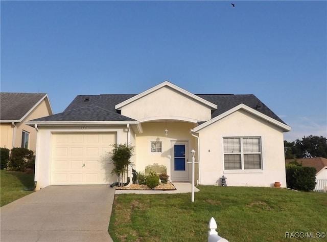 ranch-style home with a garage and a front lawn