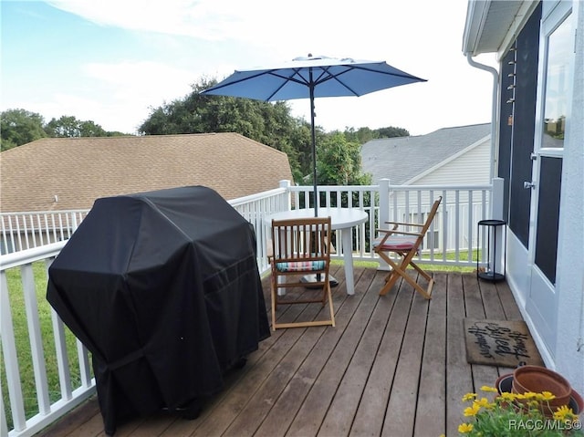 wooden deck with a grill