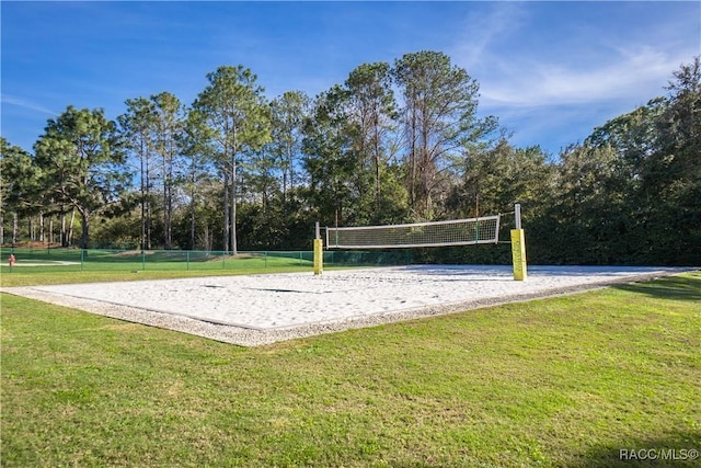 surrounding community featuring volleyball court and a lawn