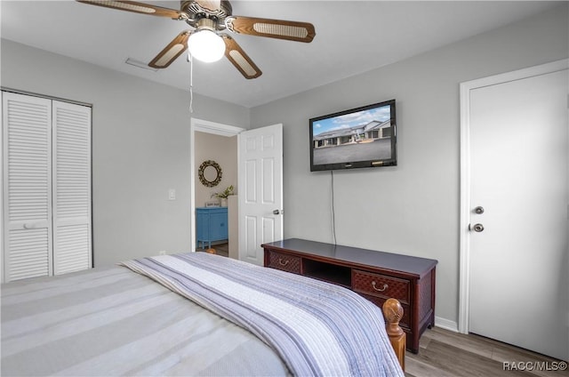 bedroom with ceiling fan, hardwood / wood-style flooring, and a closet