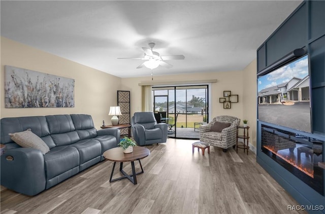 living room with ceiling fan and hardwood / wood-style floors