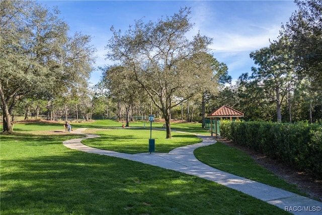 view of property's community with a lawn and a gazebo