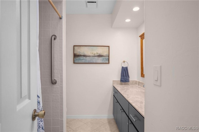 bathroom with vanity and a tile shower