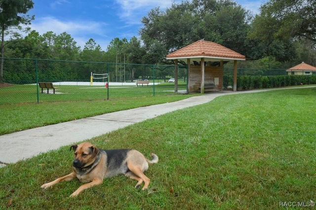 surrounding community featuring a yard and volleyball court