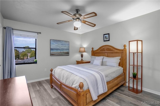 bedroom featuring light wood-type flooring and ceiling fan