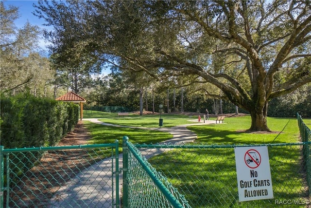 view of property's community with a lawn