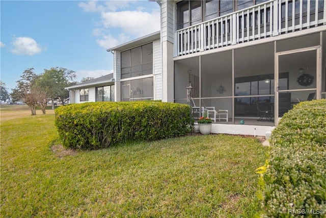 view of side of home featuring a lawn