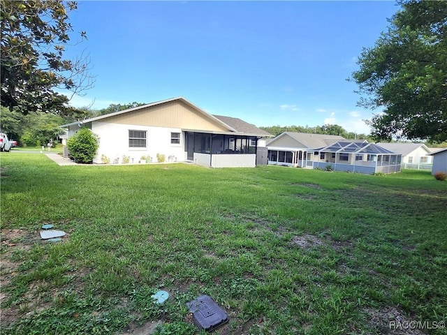 3526 N Tamarisk Ave, Beverly Hills, FL 34465 - back of house featuring a sunroom and a yard