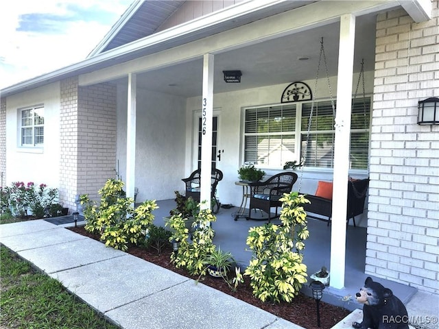 3526 N Tamarisk Ave, Beverly Hills, FL 34465 - view of exterior entry featuring brick siding and covered porch