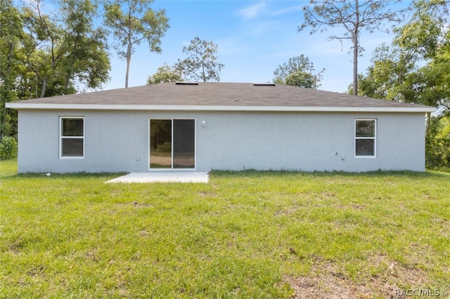 rear view of property with a patio area and a lawn