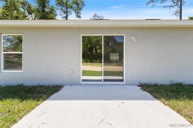 property entrance with a patio