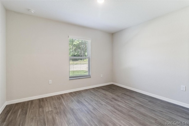 empty room featuring dark wood-type flooring