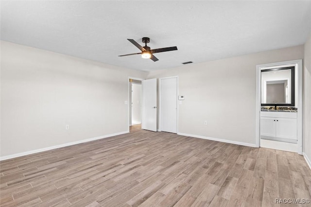 spare room with ceiling fan and light wood-type flooring