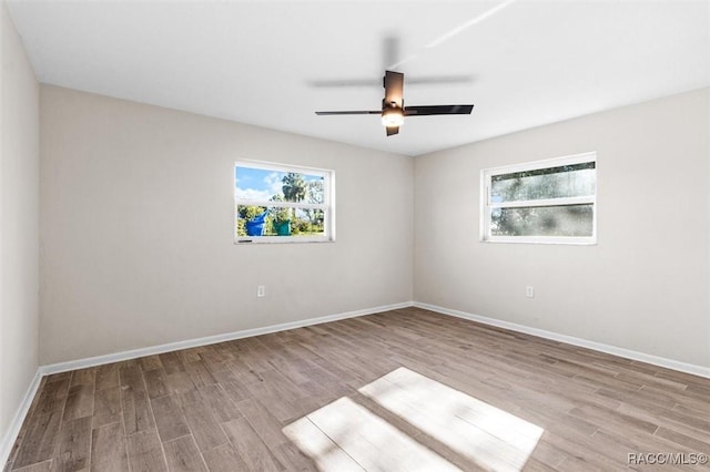 empty room with ceiling fan and light wood-type flooring