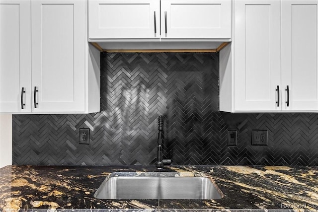 kitchen featuring tasteful backsplash and white cabinets