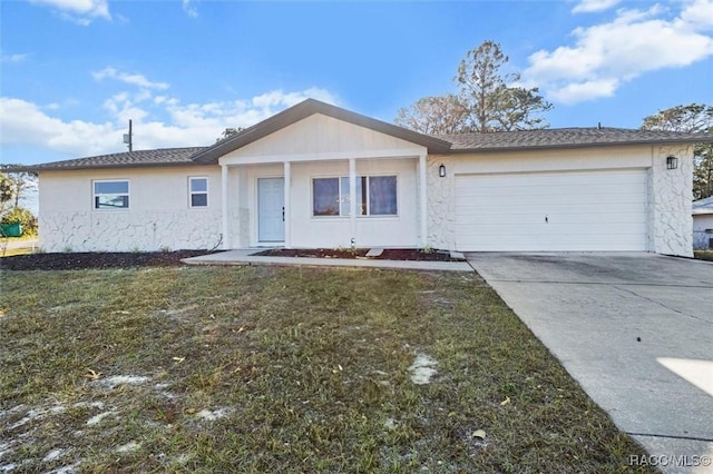 single story home featuring a garage and a front yard