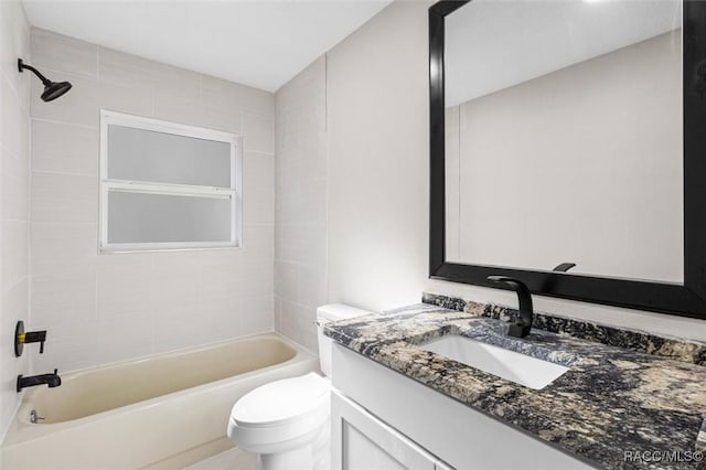 full bathroom featuring vanity, toilet, and tiled shower / bath