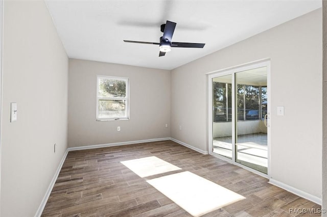 spare room featuring hardwood / wood-style floors and ceiling fan