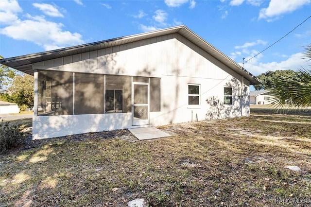 rear view of house featuring a sunroom