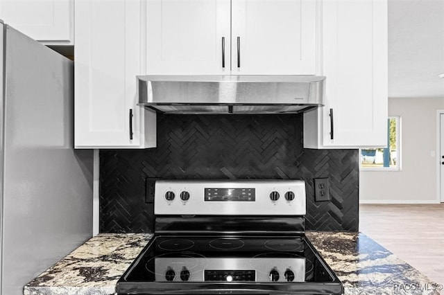 kitchen featuring white cabinetry, stainless steel electric range oven, dark stone counters, and extractor fan