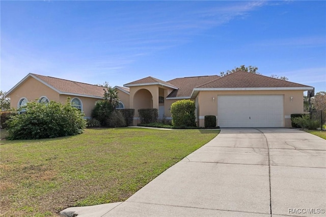 view of front of property with concrete driveway, a front lawn, an attached garage, and stucco siding