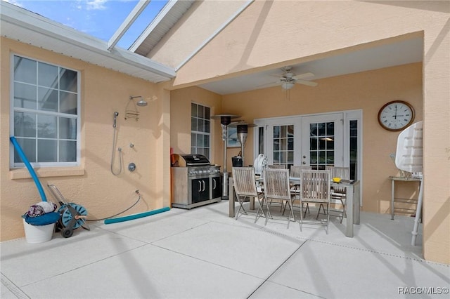 view of patio featuring ceiling fan, french doors, and area for grilling