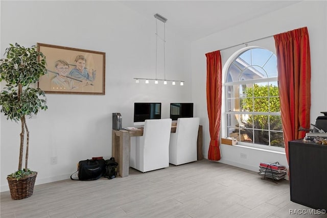 home office featuring plenty of natural light and light hardwood / wood-style floors