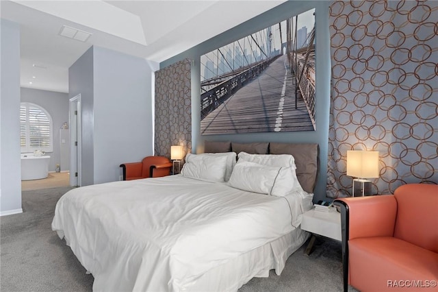 carpeted bedroom featuring wallpapered walls, visible vents, an accent wall, and baseboards