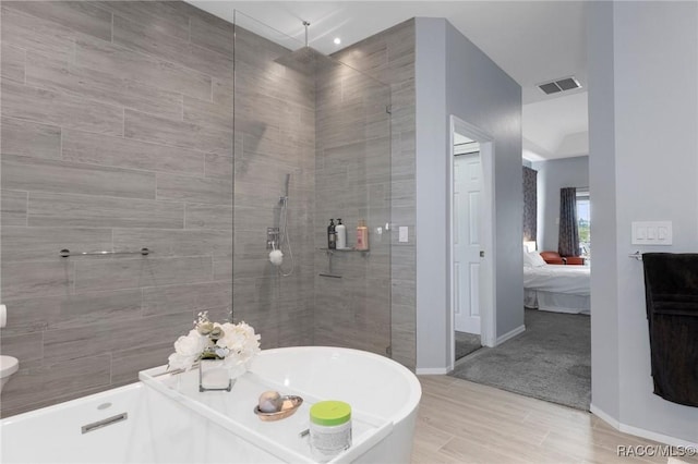 ensuite bathroom featuring visible vents, baseboards, a soaking tub, ensuite bath, and walk in shower