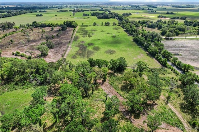 birds eye view of property with a rural view