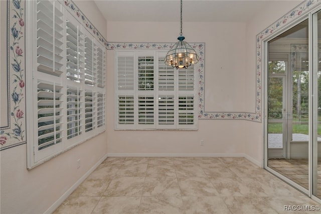 unfurnished room with an inviting chandelier