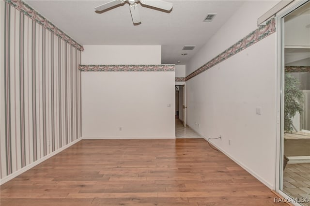 empty room with light wood-type flooring and ceiling fan