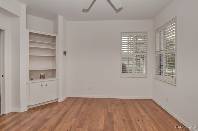 spare room featuring ceiling fan and light wood-type flooring