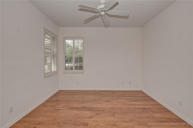 spare room with ceiling fan and light wood-type flooring