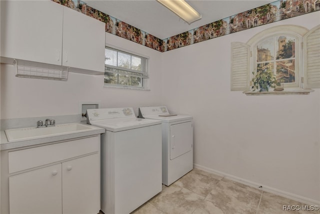 laundry room with cabinets, separate washer and dryer, and sink