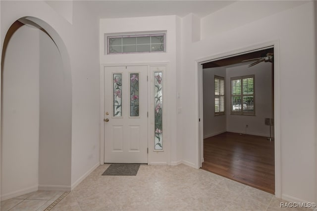 foyer entrance with ceiling fan and light hardwood / wood-style flooring