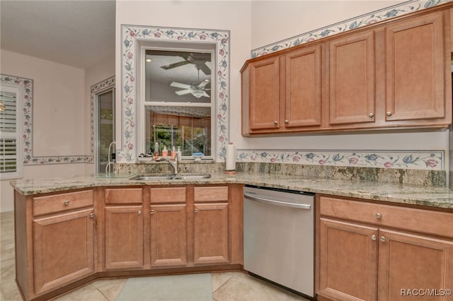 kitchen with dishwasher, sink, ceiling fan, light tile patterned flooring, and light stone counters