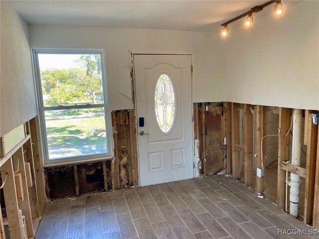 dining area with hardwood / wood-style floors and wooden walls