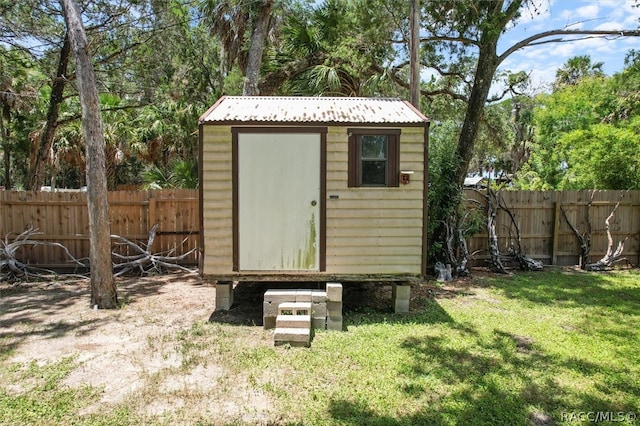 view of outbuilding with a yard