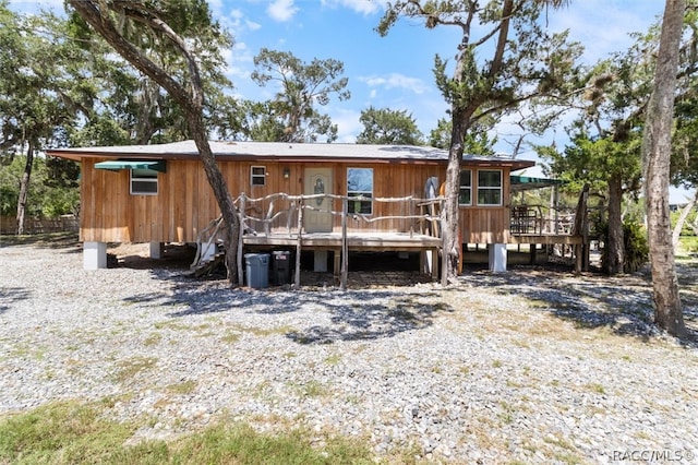 rear view of house with a wooden deck