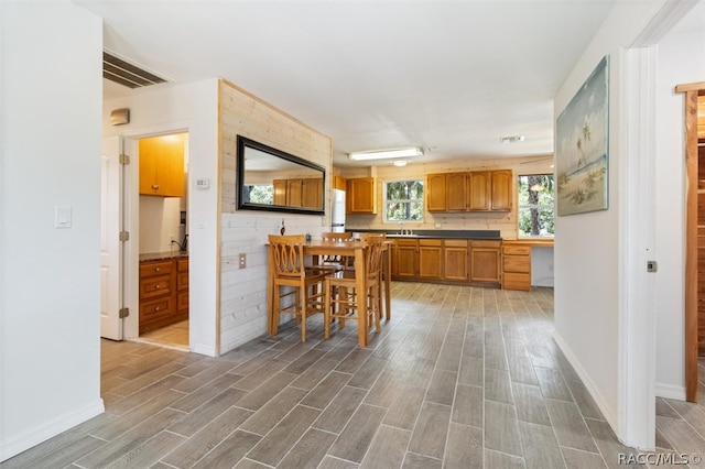 kitchen with a breakfast bar, sink, and dark hardwood / wood-style floors